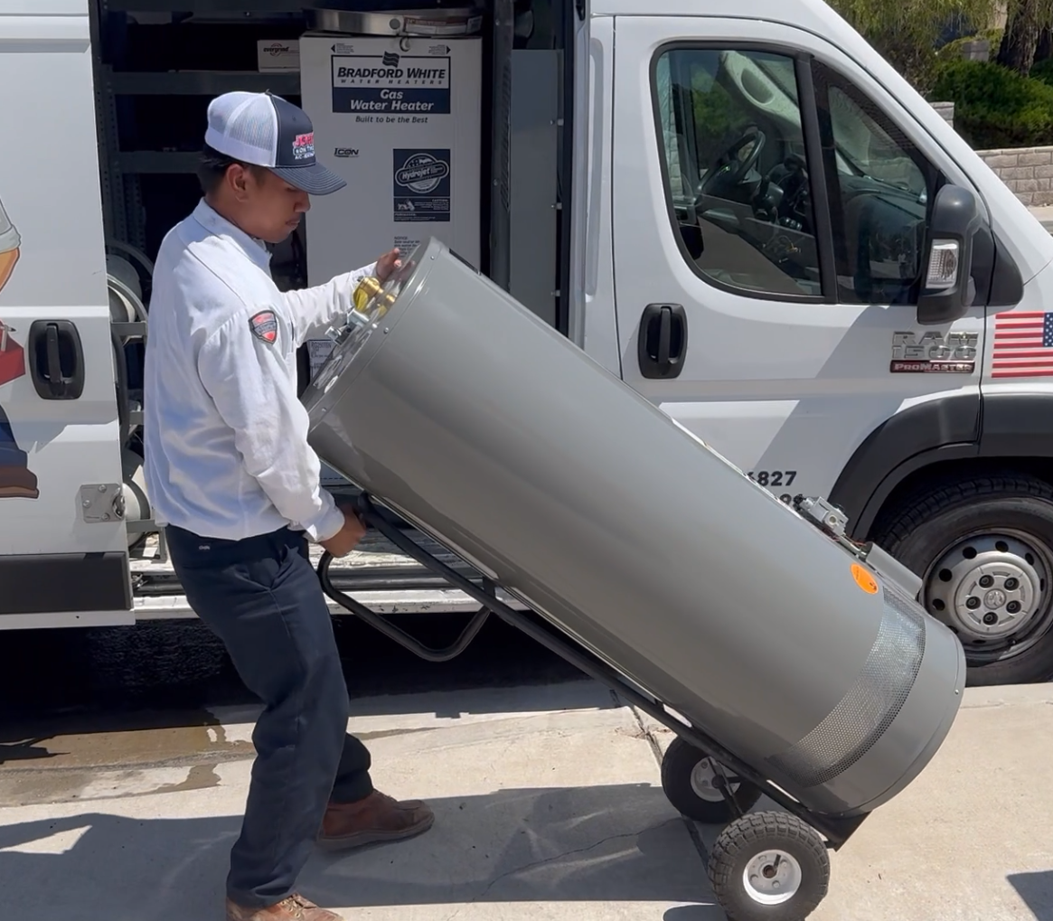HVAC tech transporting new gas water heater using dolly. 