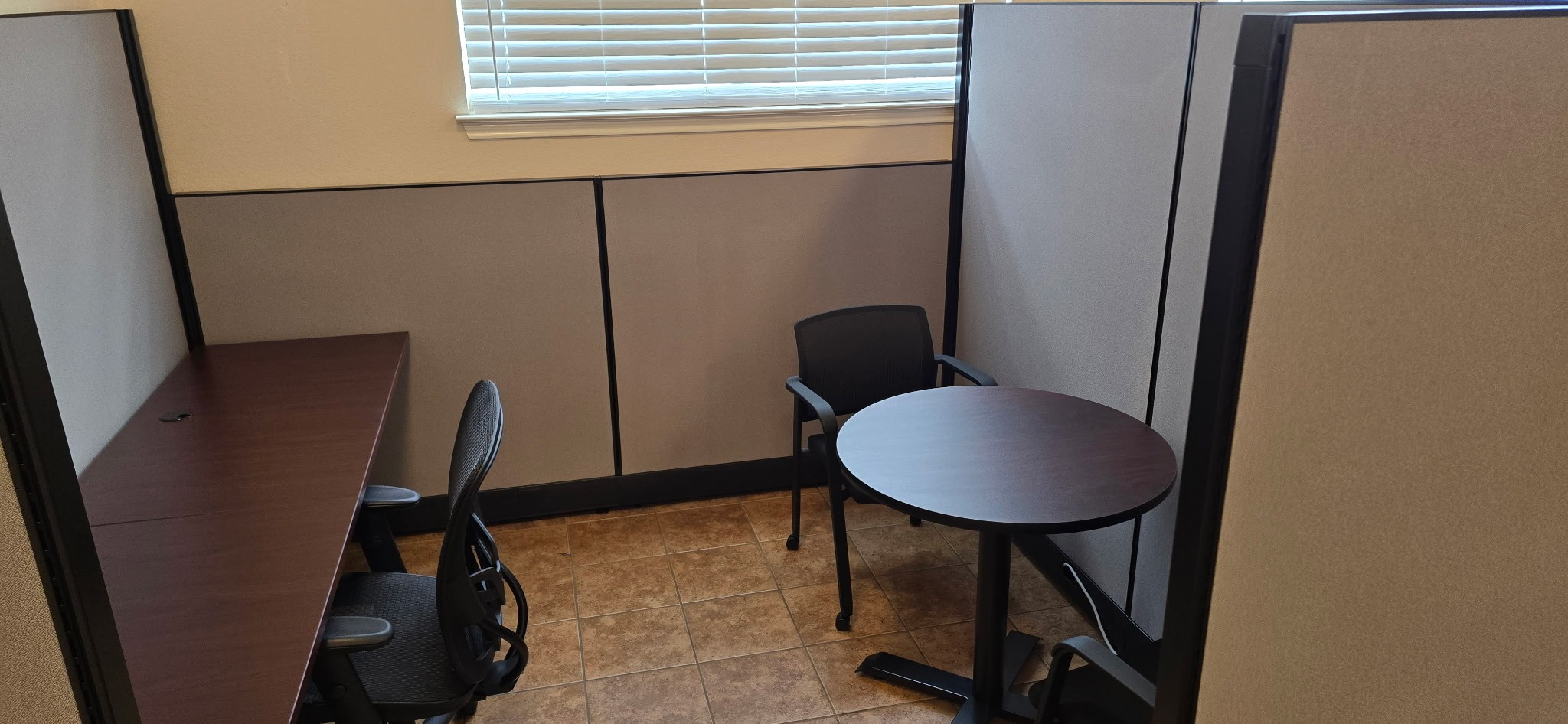Acoustic Privacy Booth:

Compact acoustic phone booth / solo work pod featuring warm wood wall paneling and integrated seating for private calls or quiet work.