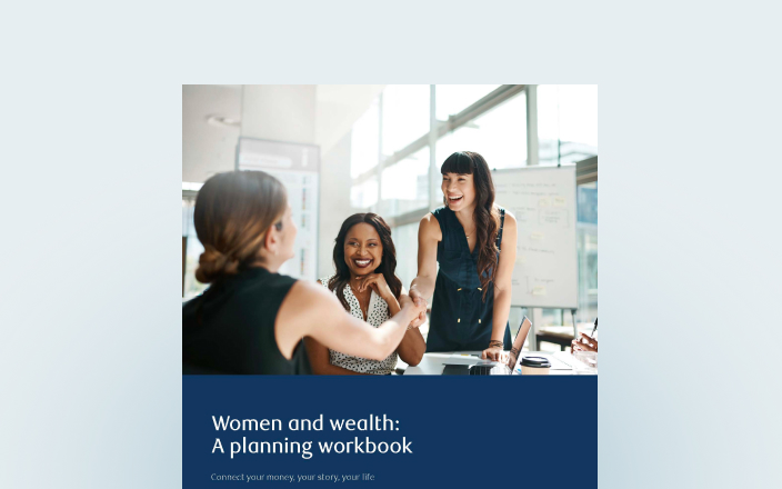Cover of the women and wealth planning workbook with female professionals shaking hands.
