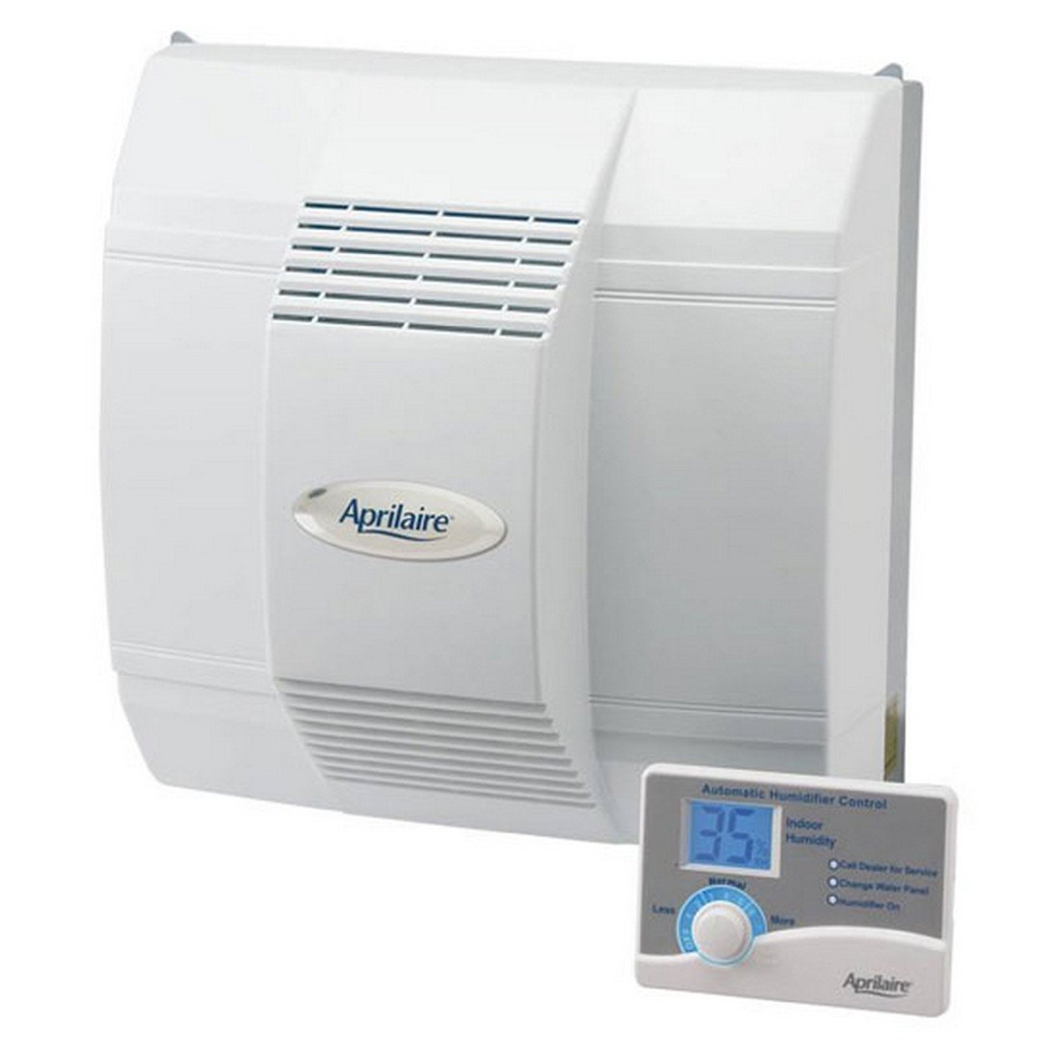A white Aprilaire whole-house humidifier is mounted on a wall, with its digital control panel displayed in the foreground. The humidifier unit has a series of horizontal vents near the top and bottom. The control panel features a digital display showing '35' for indoor humidity, along with options for 'Less' and 'More' humidity adjustment, and status indicators for 'Call Dealer for Service', 'Change Water Panel', and 'Humidifier On'.