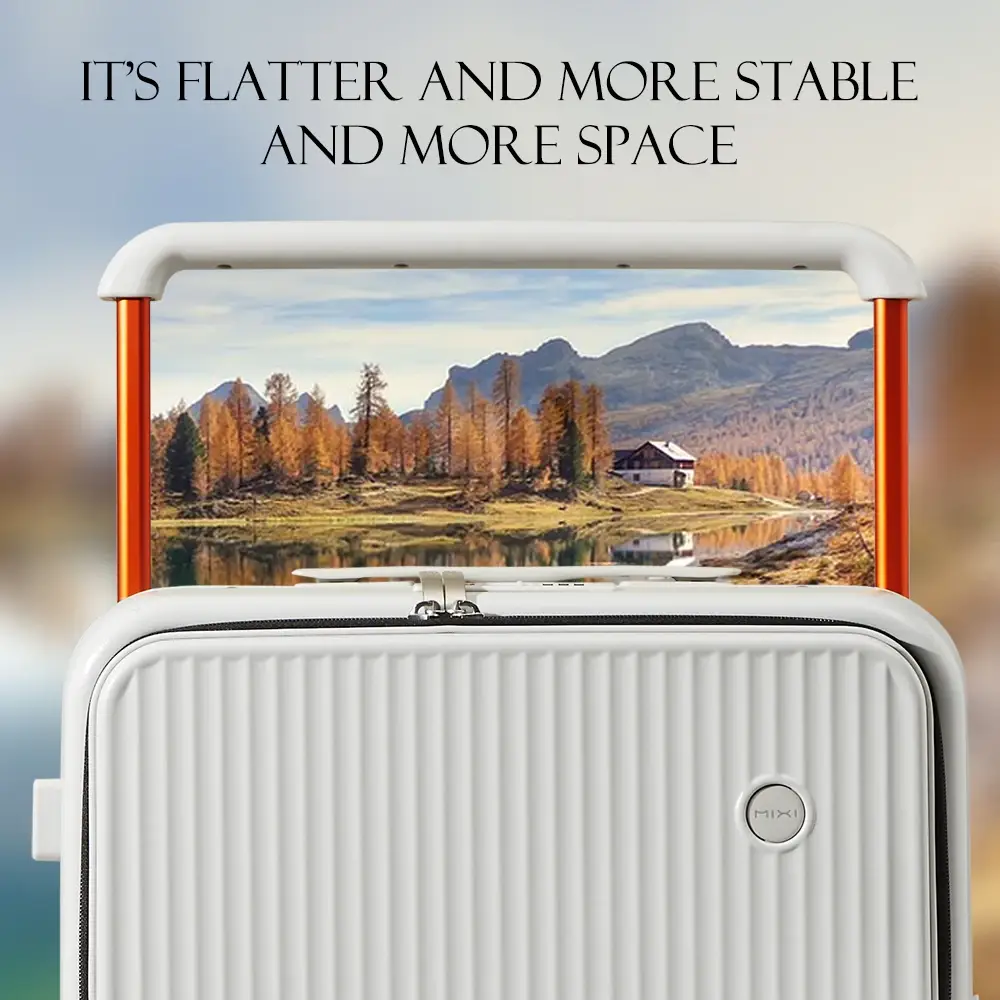 A close-up shot of a white, ribbed suitcase with orange accents, featuring a scenic image of a lake, autumn trees, and mountains displayed on its surface. The text "IT'S FLATTER AND MORE STABLE AND MORE SPACE" is overlaid at the top.