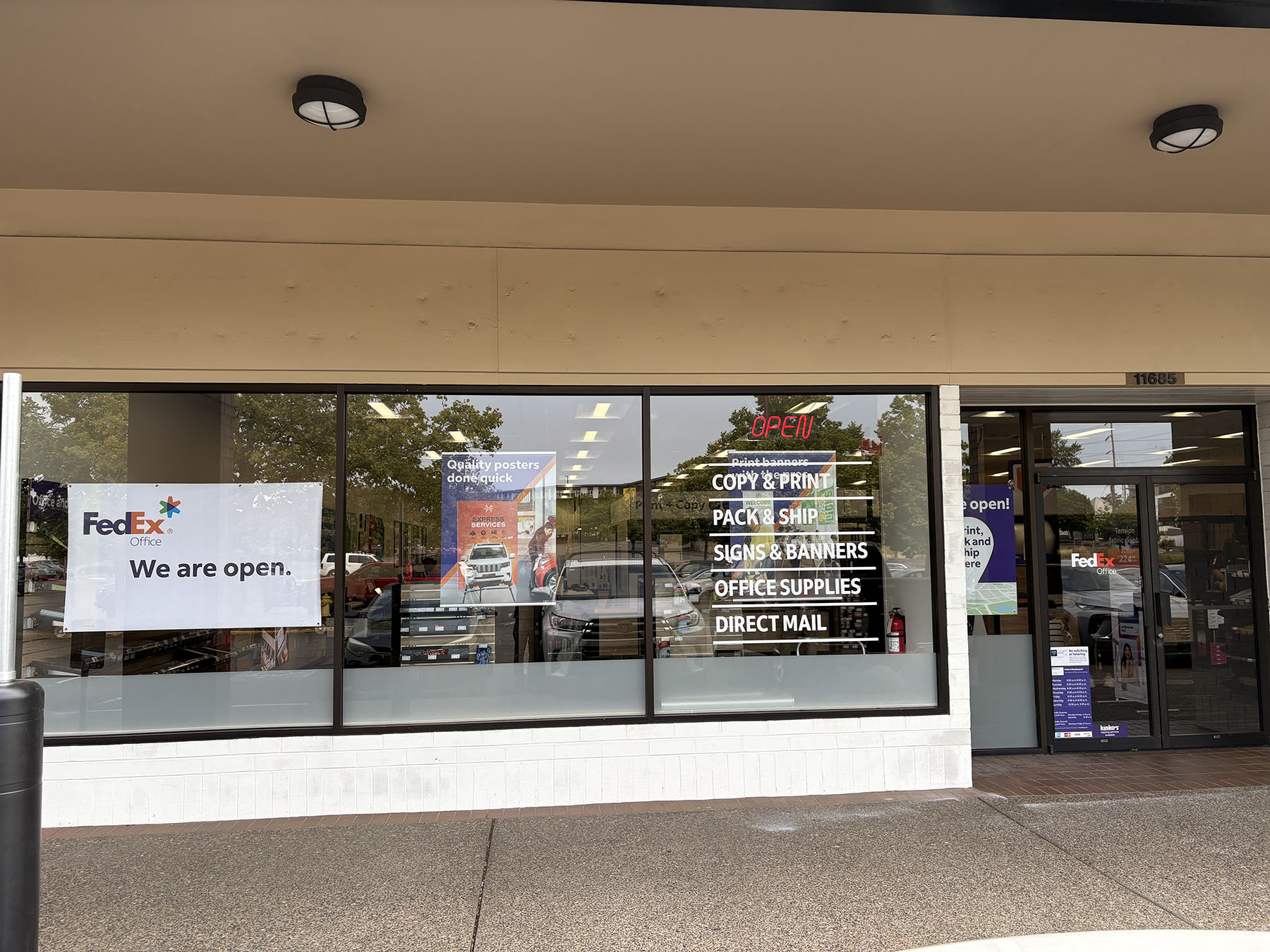 Front Windows and Store Entrance &ndash; Storefront windows at FedEx Office Beaverton highlighting printing, packing, shipping, signs and banners, and direct mail services.