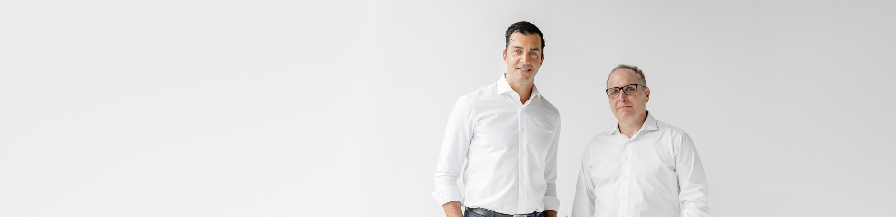 Jeffrey Wellwood and Matt Barasch standing side by side.