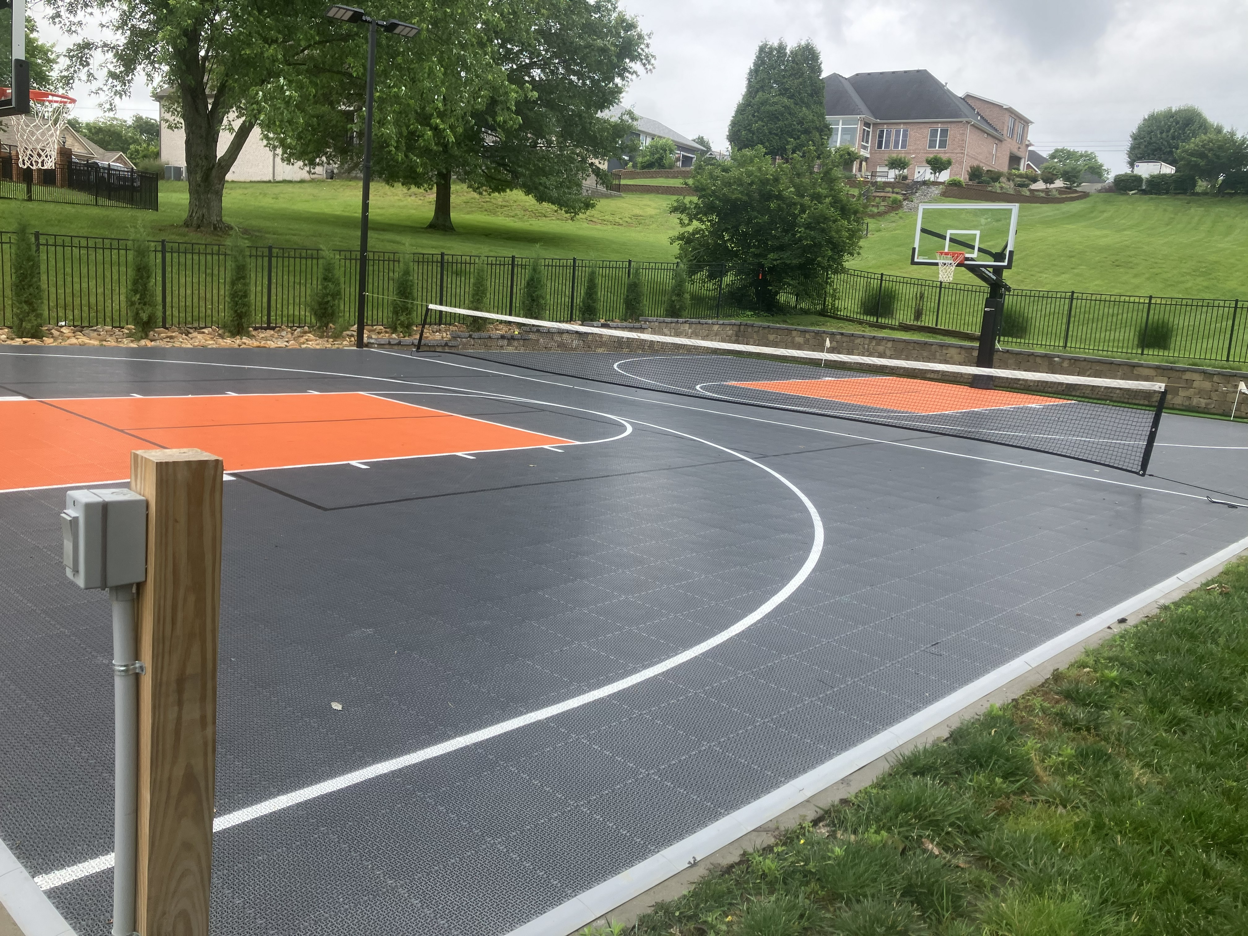 Outdoor backyard basketball and tennis court.
