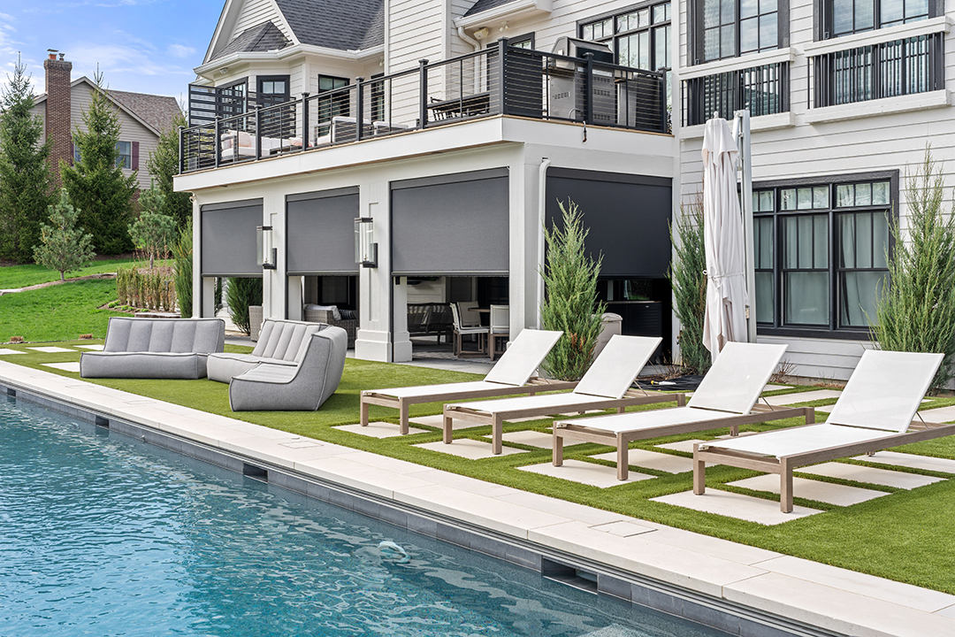 Outdoor roller shades create a protected outdoor space.