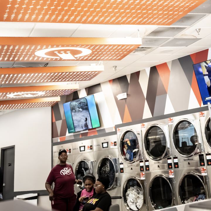 Clean, brightly lit Speed Queen Laundry featuring rows of commercial washers and dryers in a modern  