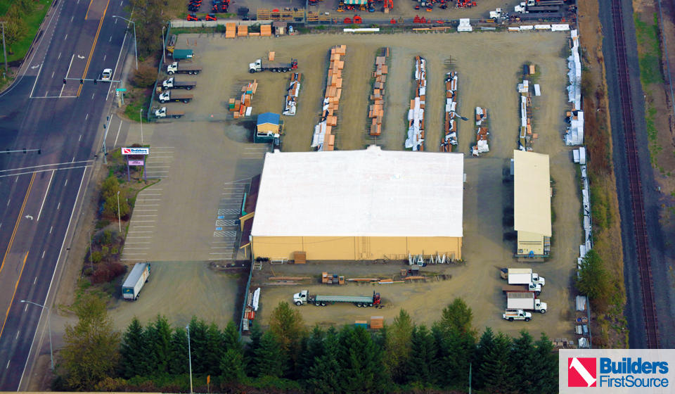 Building materials supplier Builders FirstSource's forklift is moving wood roof trusses.