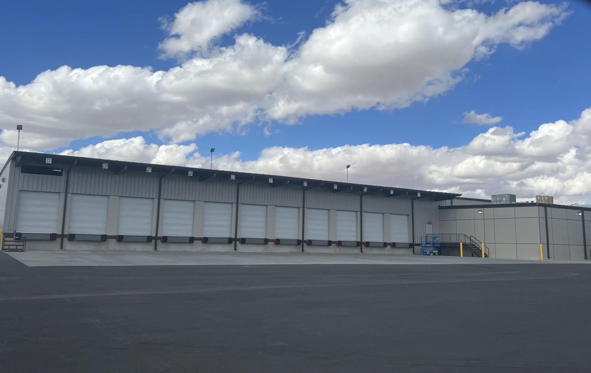 Industrial warehouse with pre-engineered metal building and multiple loading bay doors built by commercial general contractor