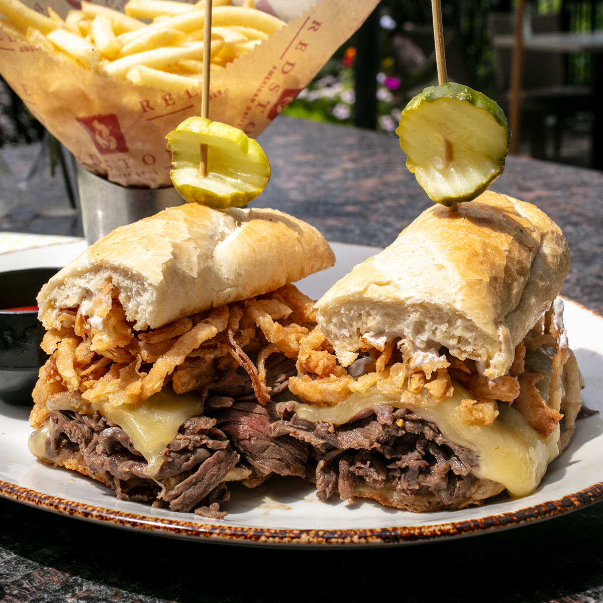 Redstone Tenderloin Dip | 1/2lb of steak, hoagie, swiss, au jus, onion strings, horseradish sauce