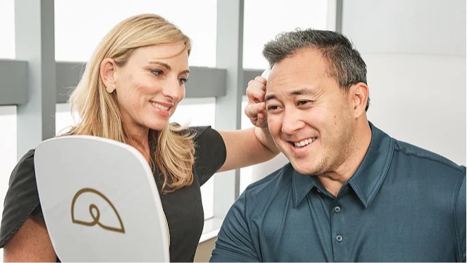 A male patient receiving a hair consultation.