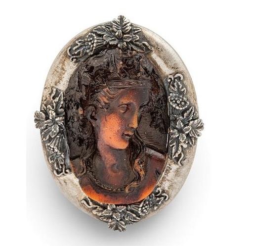 An cast resin cameo set in sterling silver having finely detailed flower decorations. Stamped 925 to the back.