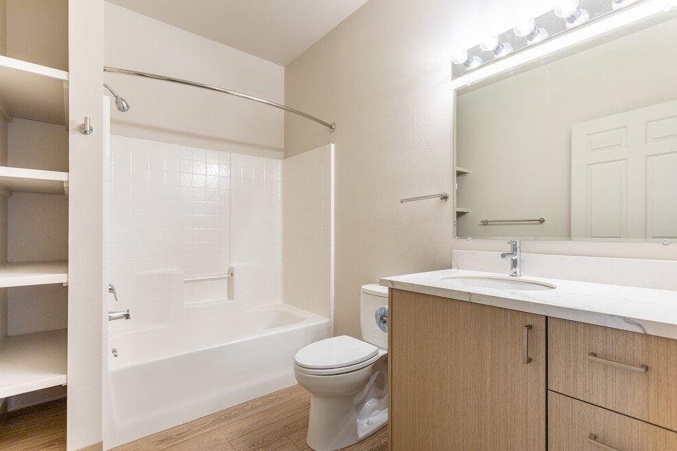 A white bathroom with a toilet, sink, and bathtub