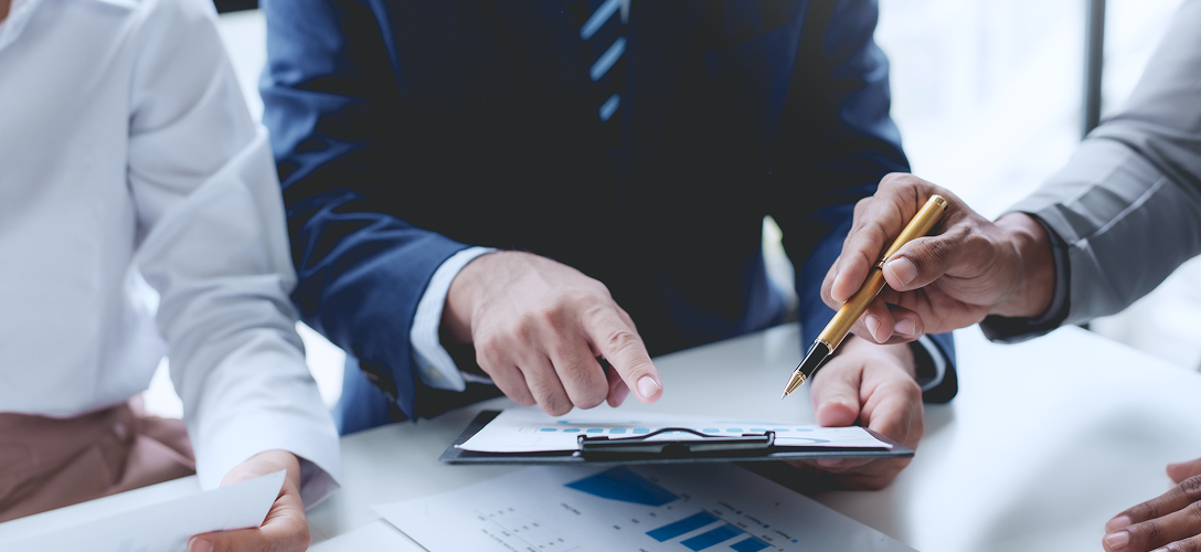 Commercial bankers reviewing documents.