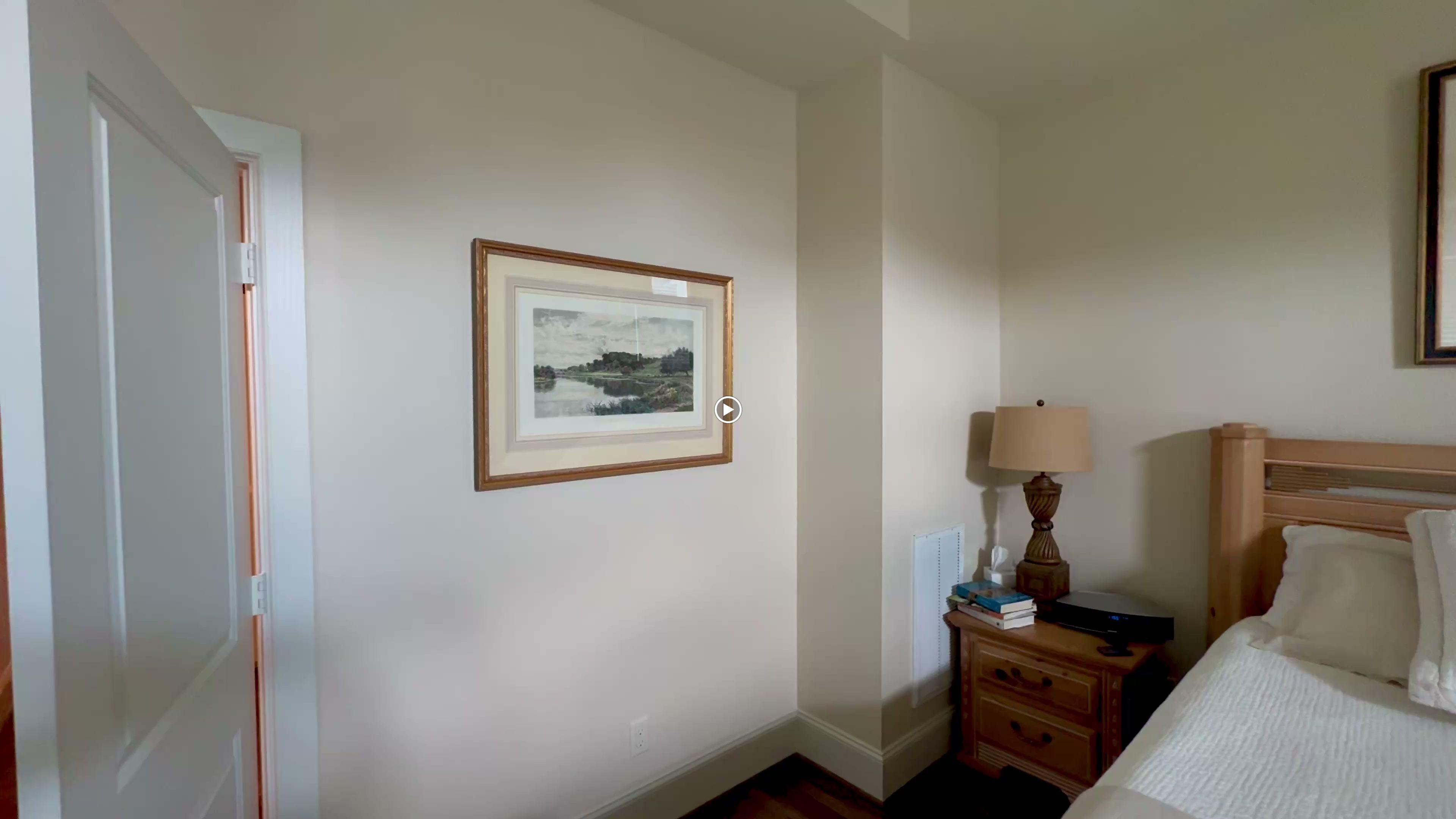 Framed wall art professionally installed on a bedroom wall and one above a bed in a residential home.