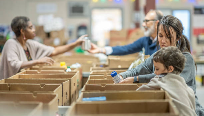 Individuals volunteering at a food bank.