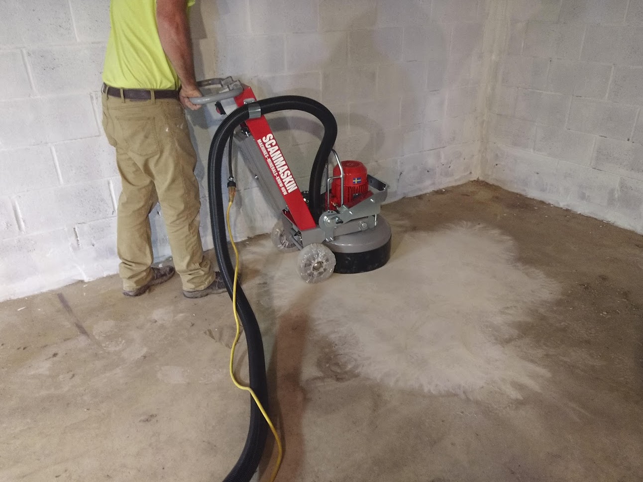 Basement Epoxy floor finish preparation using proper equipment.