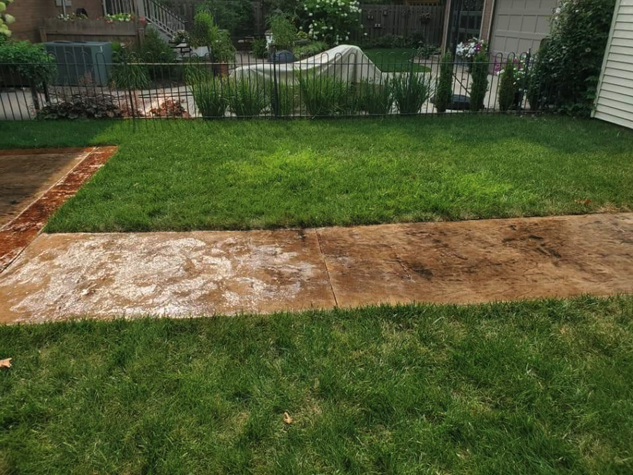 We worked on this backyard last season, creating a patio, and a stamped concrete sidewalk. The owner of this home in Maineville, Ohio wanted the surface to look like a slab of natural rock. I think we got the stamp and stain color right! Are you looking to transform your backyard? Reach out to us to talk about your project.