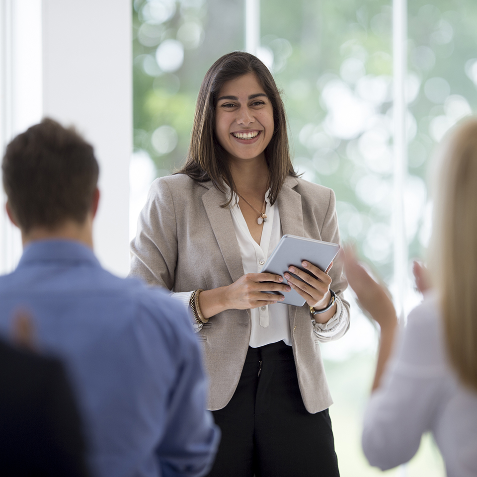 A woman standing in front of a few people