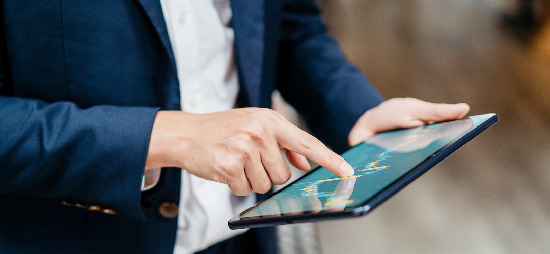 Close-up of a person looking at a graph on their tablet.