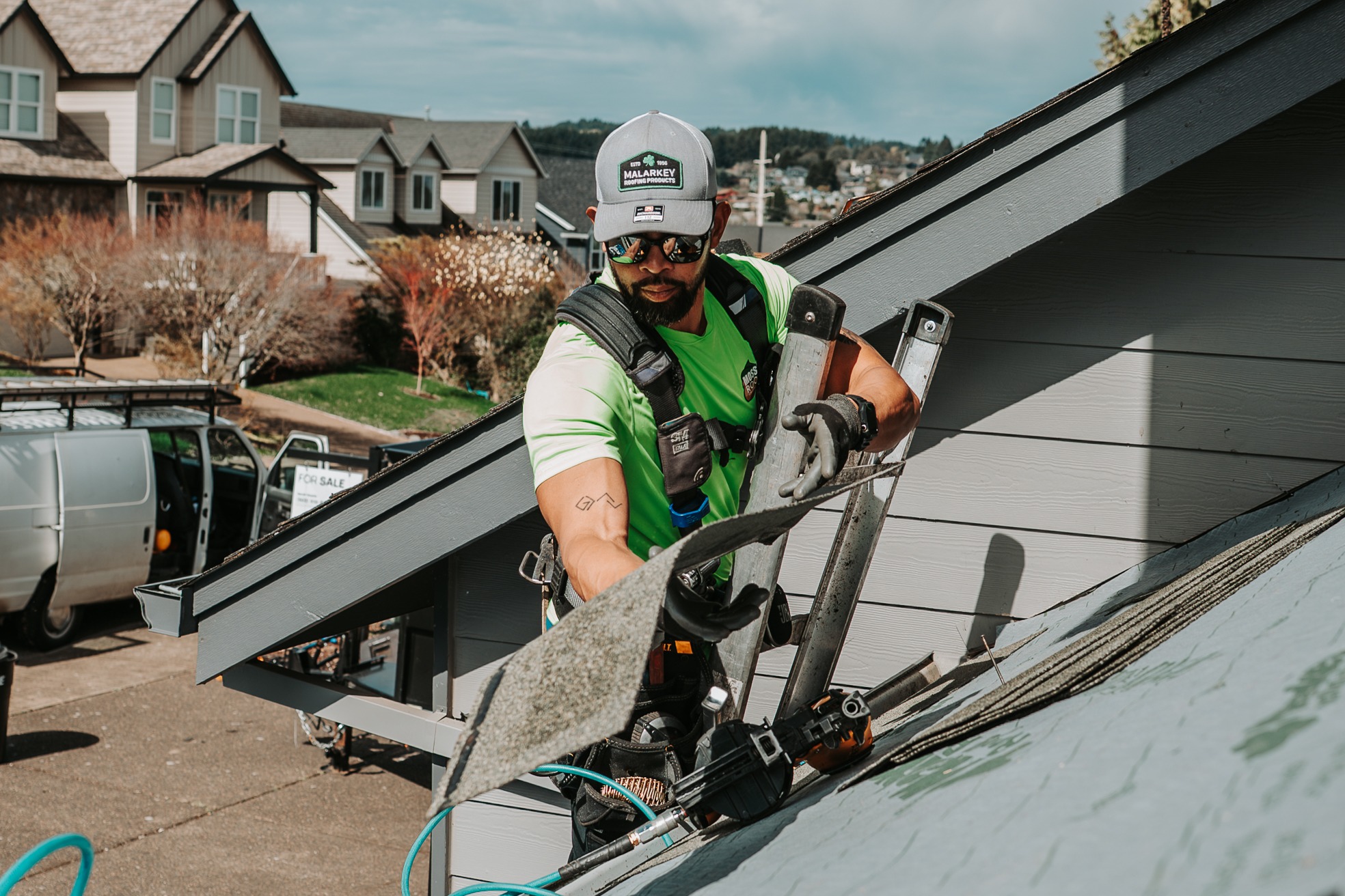 Roofing crew completing installation work on a residential home. 