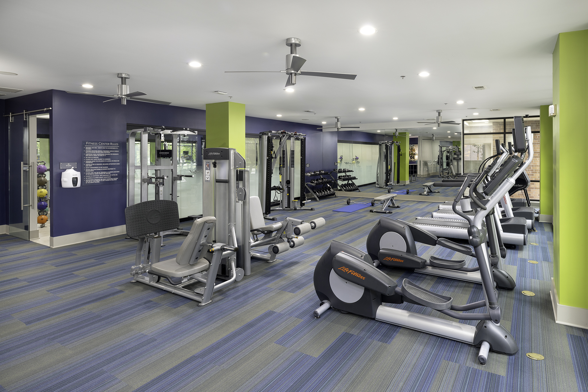 Fitness center with cardio and strength training equipment including a TRX system at Camden Buckhead Square apartments in Atlanta, GA