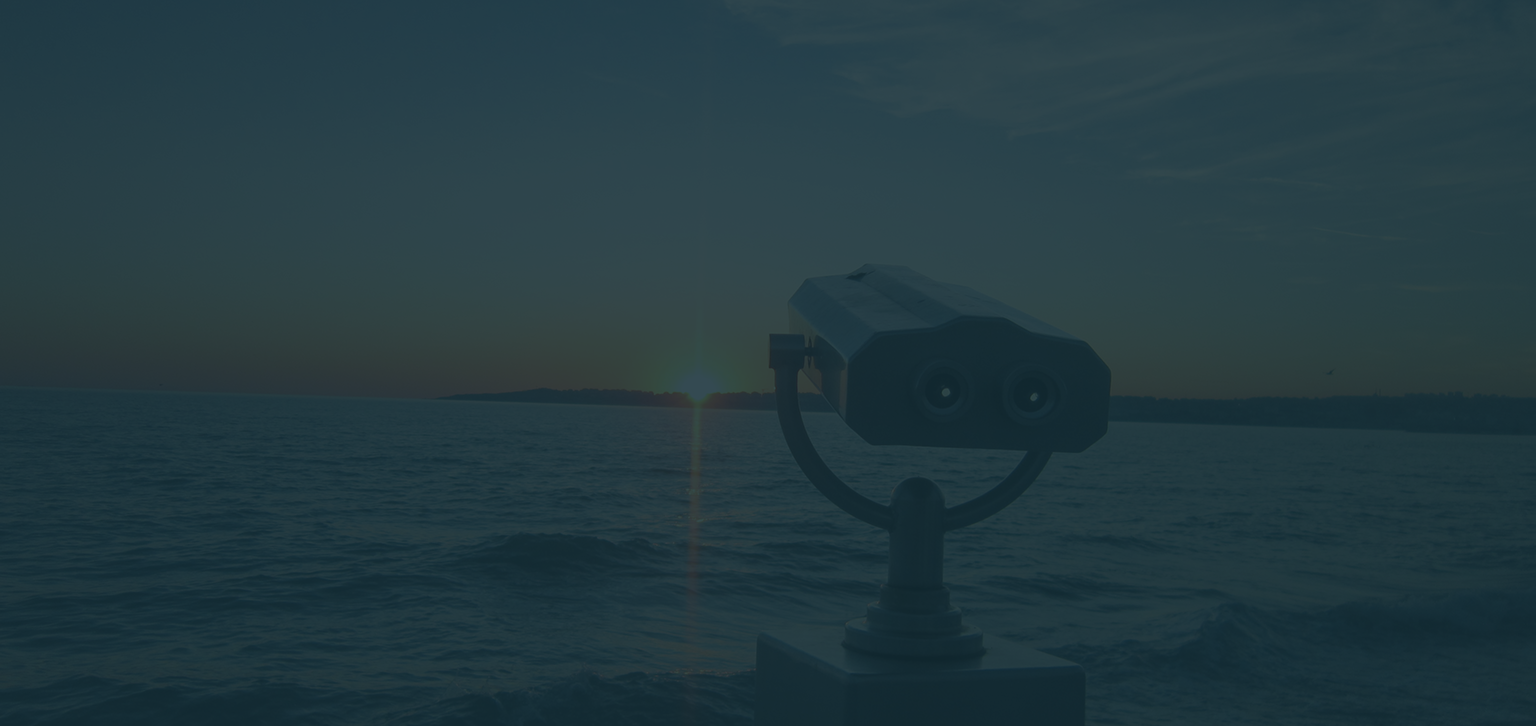 Observation viewer over a wavey body of water at sunset.