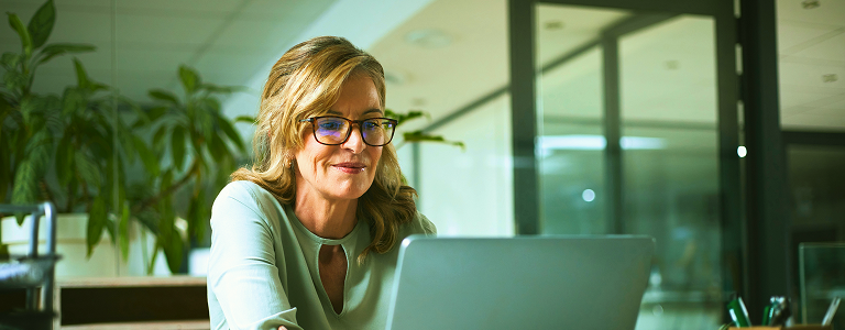 A woman working on a laptop.