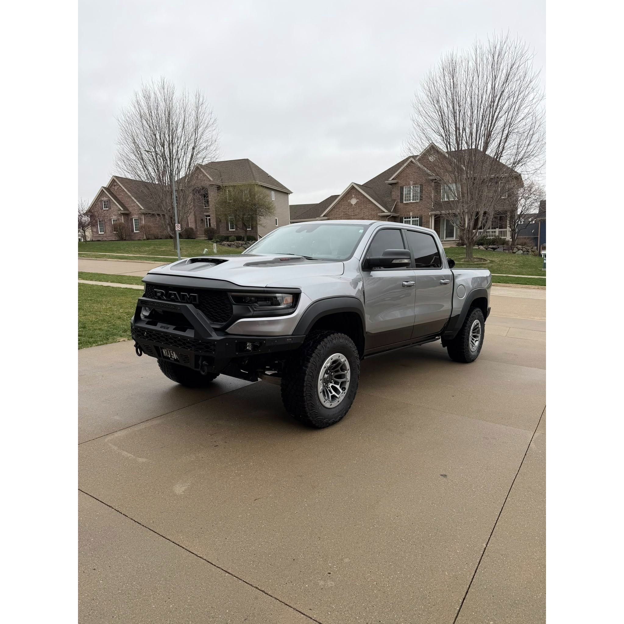 Silver RAM truck parked in a residential driveway after mobile detailing, highlighting exterior cleaning, tire care, and professional truck detailing service.