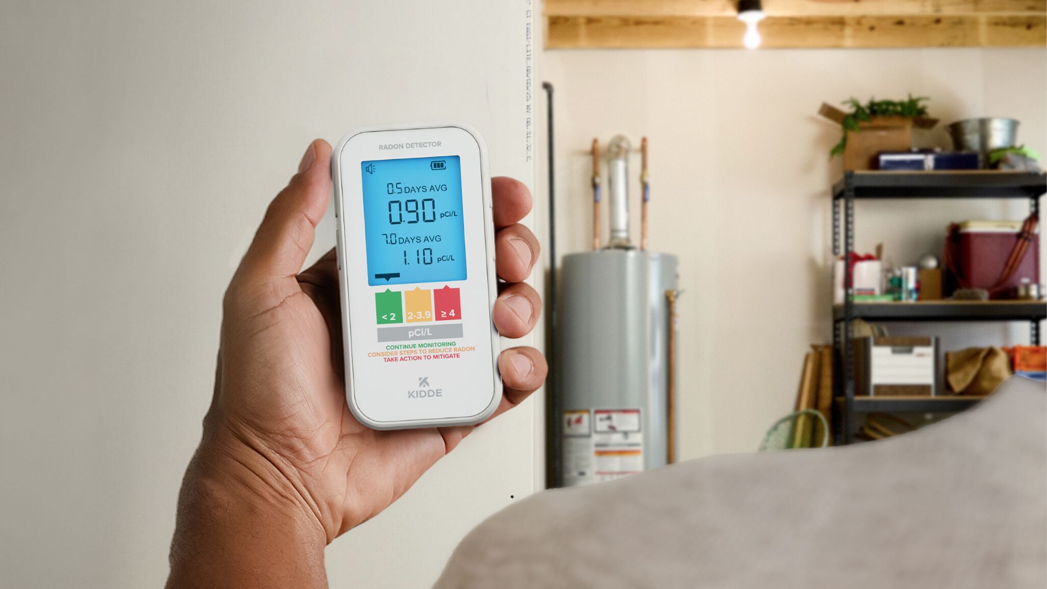 A picture of a person holding a radon detector in a basement.
