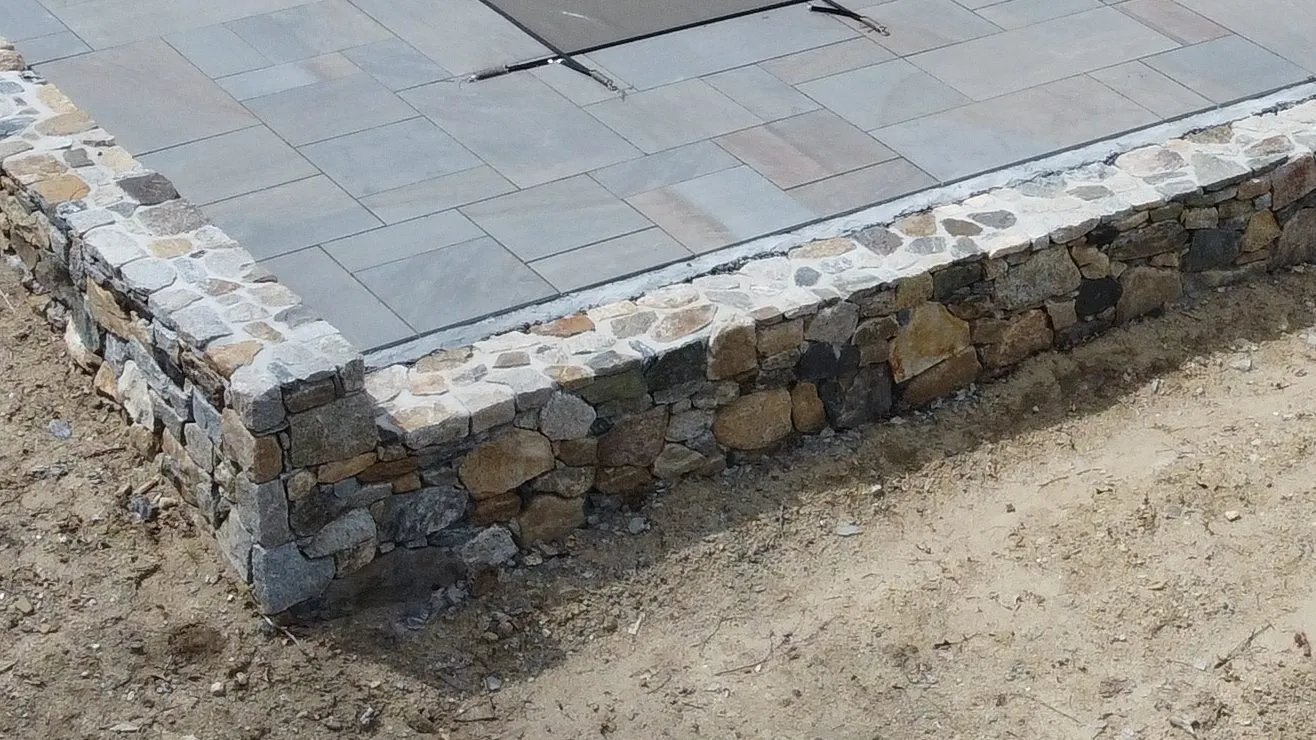 Aerial view of a natural stone retaining wall in Connecticut - Stone Retaining Walls project by General Masonry LLC.