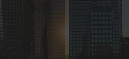 A bottom-up view of a spiral staircase and chandelier.