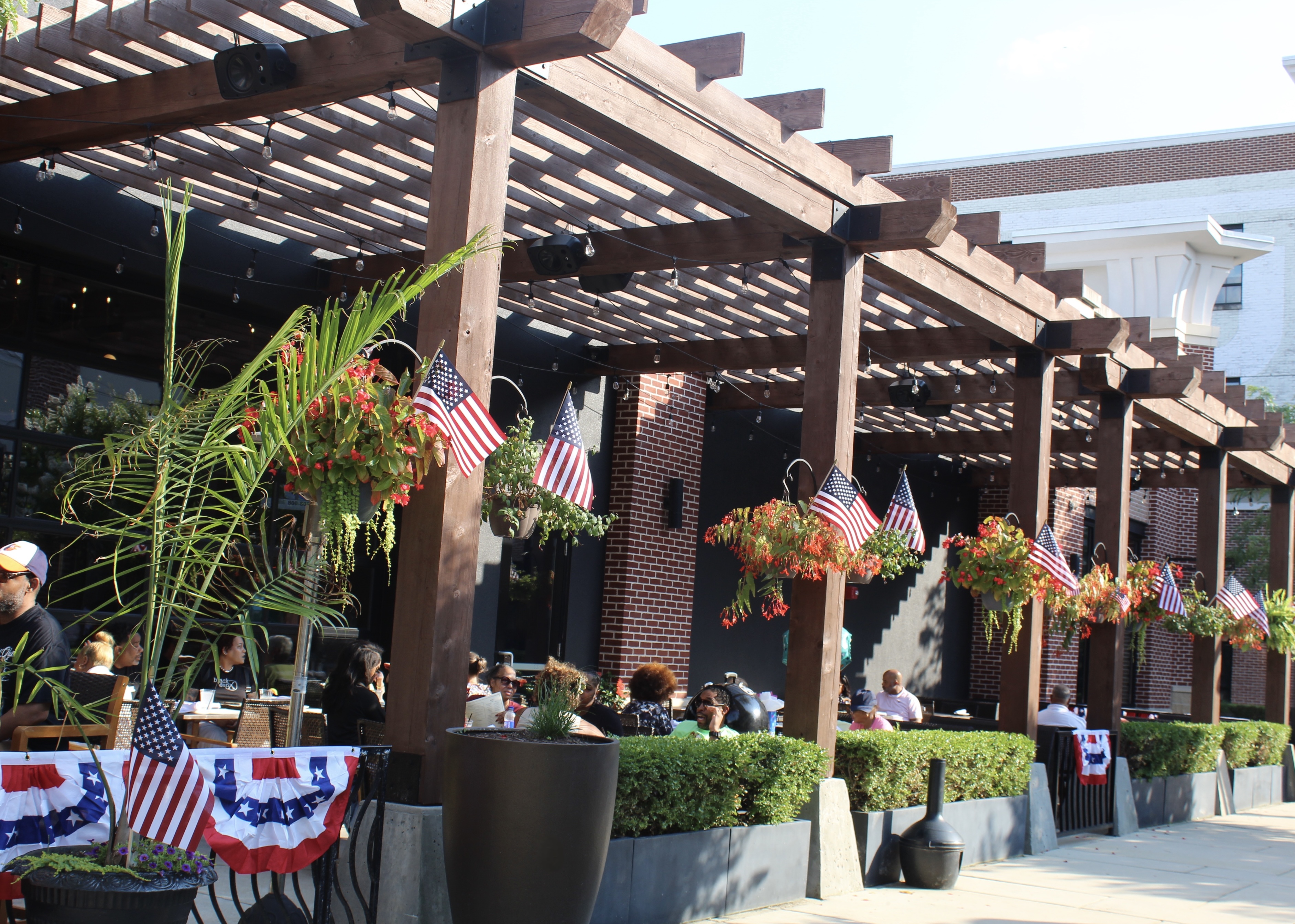 Mama's On The Half Shell Owings Mills Patio Dining Area, dressed with American flags for Fourth of J 