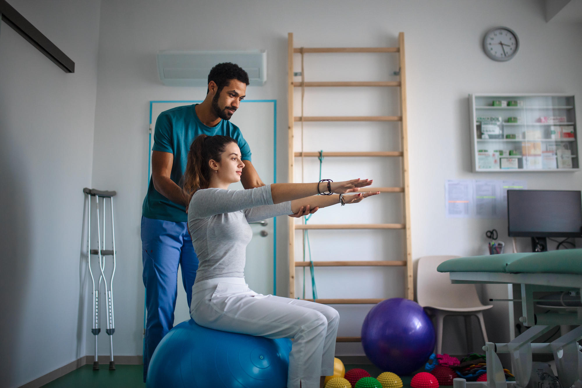 woman sitting doing physical therapy exercises