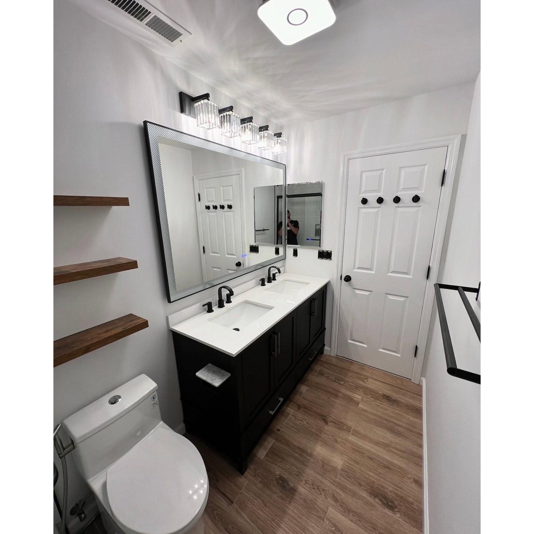 Bold contrast meets smart home storage. Combining deep dark tones with warm, open wood shelving creates an undeniably sophisticated modern style. Search for custom cabinets near me or let us build your full layout from scratch.
