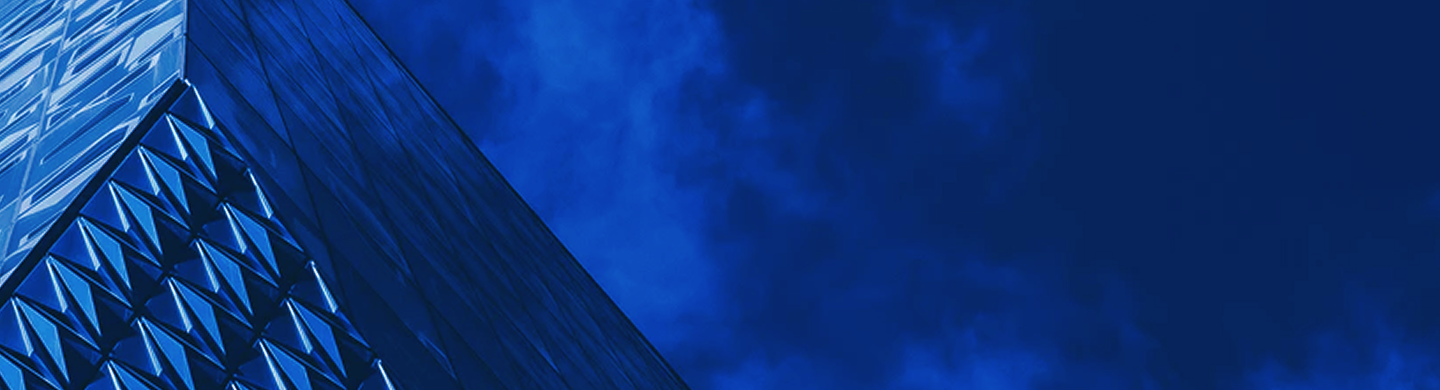 Reflective pyramid-shaped building with angled glass windows.