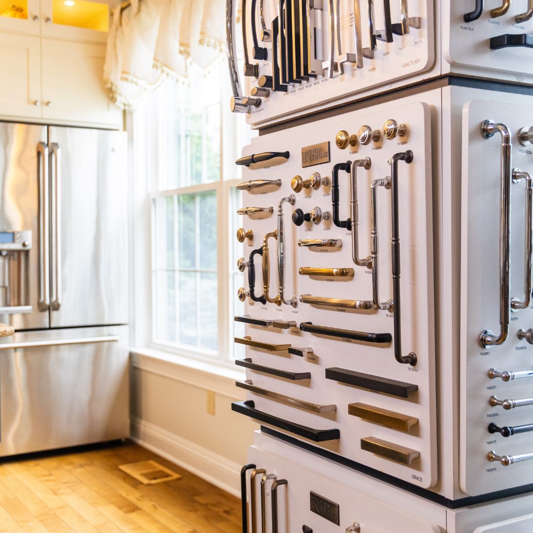 Display towers filled with Top Knobs cabinet hardware options in a sunlit section of the showroom.