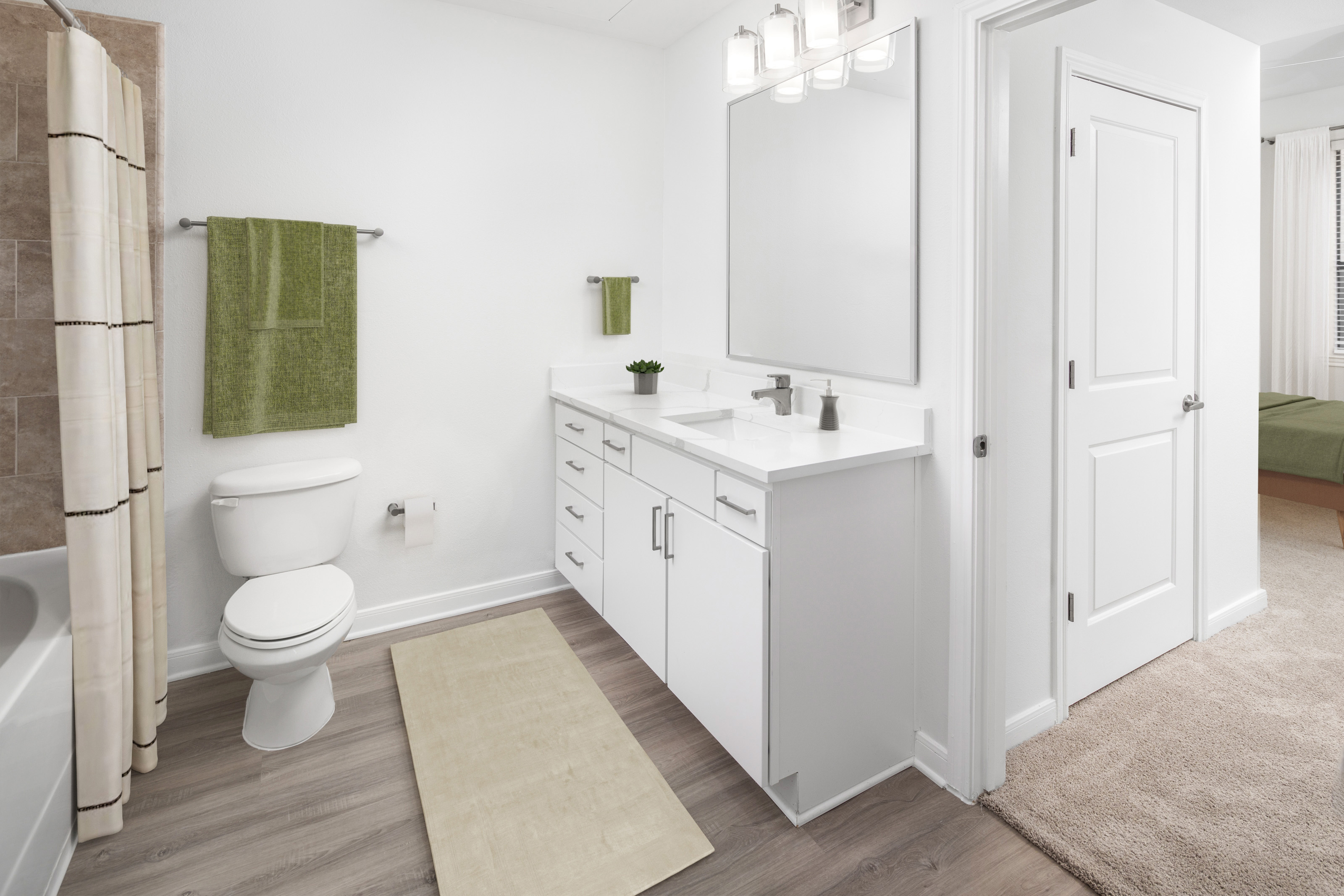 Modern finish bathrooms with white custom cabinetry and white quartz countertops at Camden Travis Street Apartments in Midtown Houston, Tx