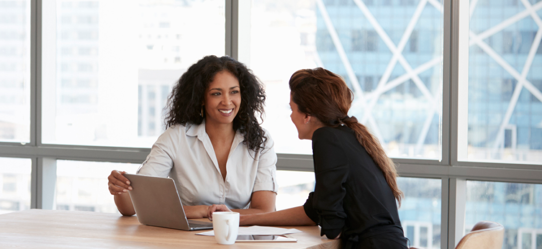Two people in a boardroom.