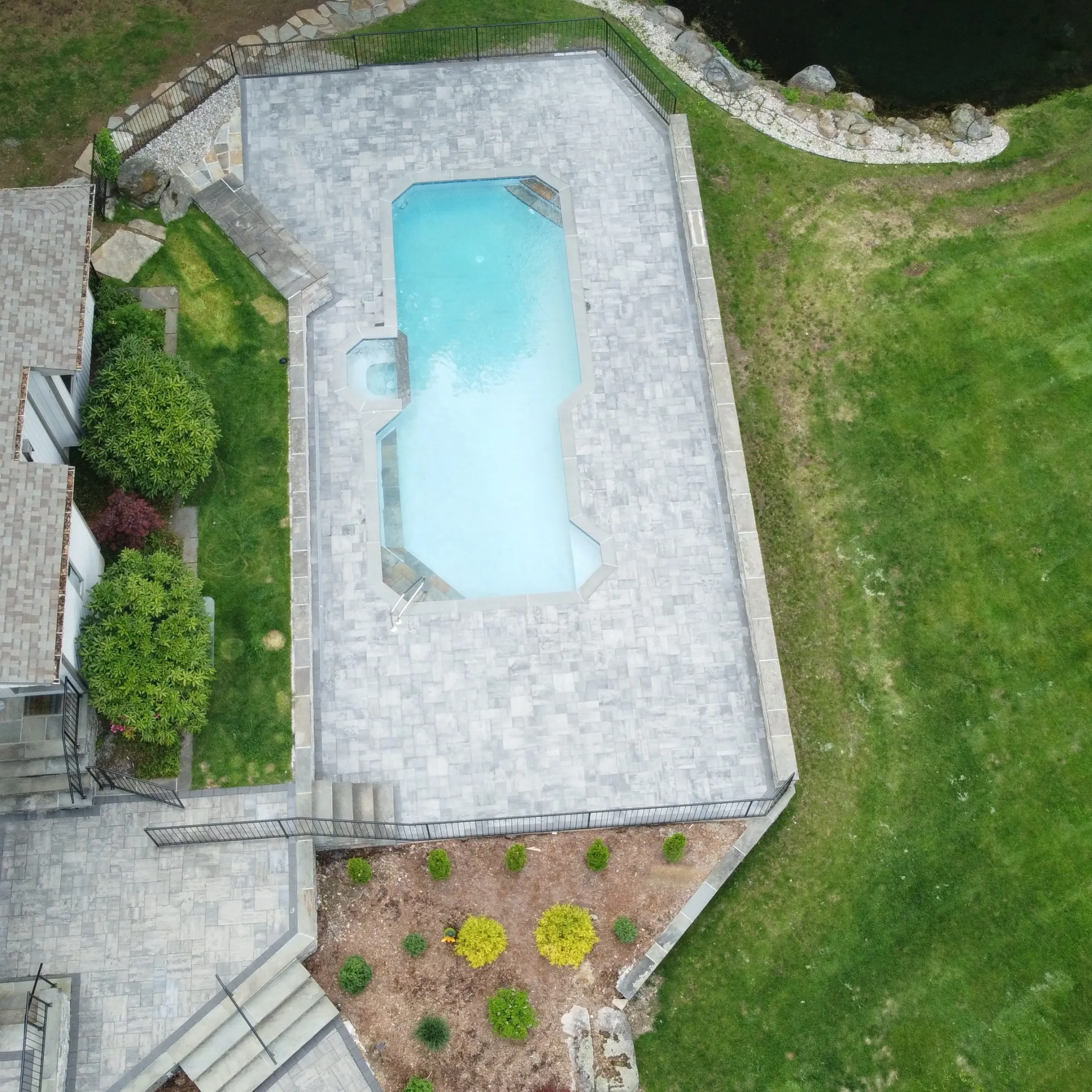 Overhead view of a paver pool deck in Southbury CT - Paver Pool Deck, Southbury project by General Masonry LLC.
