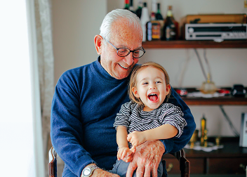 A grandfather holding his grandson.