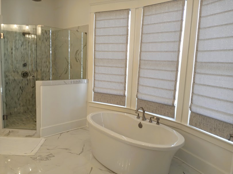 This beautiful custom bathroom gives us the chills! There are all shades of grey from the bathroom tile to the marble floor. Roman Shades that are grey flecked with silver are the perfect element for privacy while bringing a layer of glam!