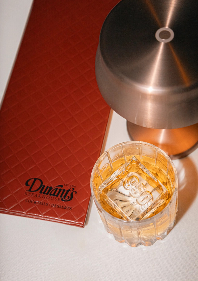 Durant's menu next to an old fashioned cocktail