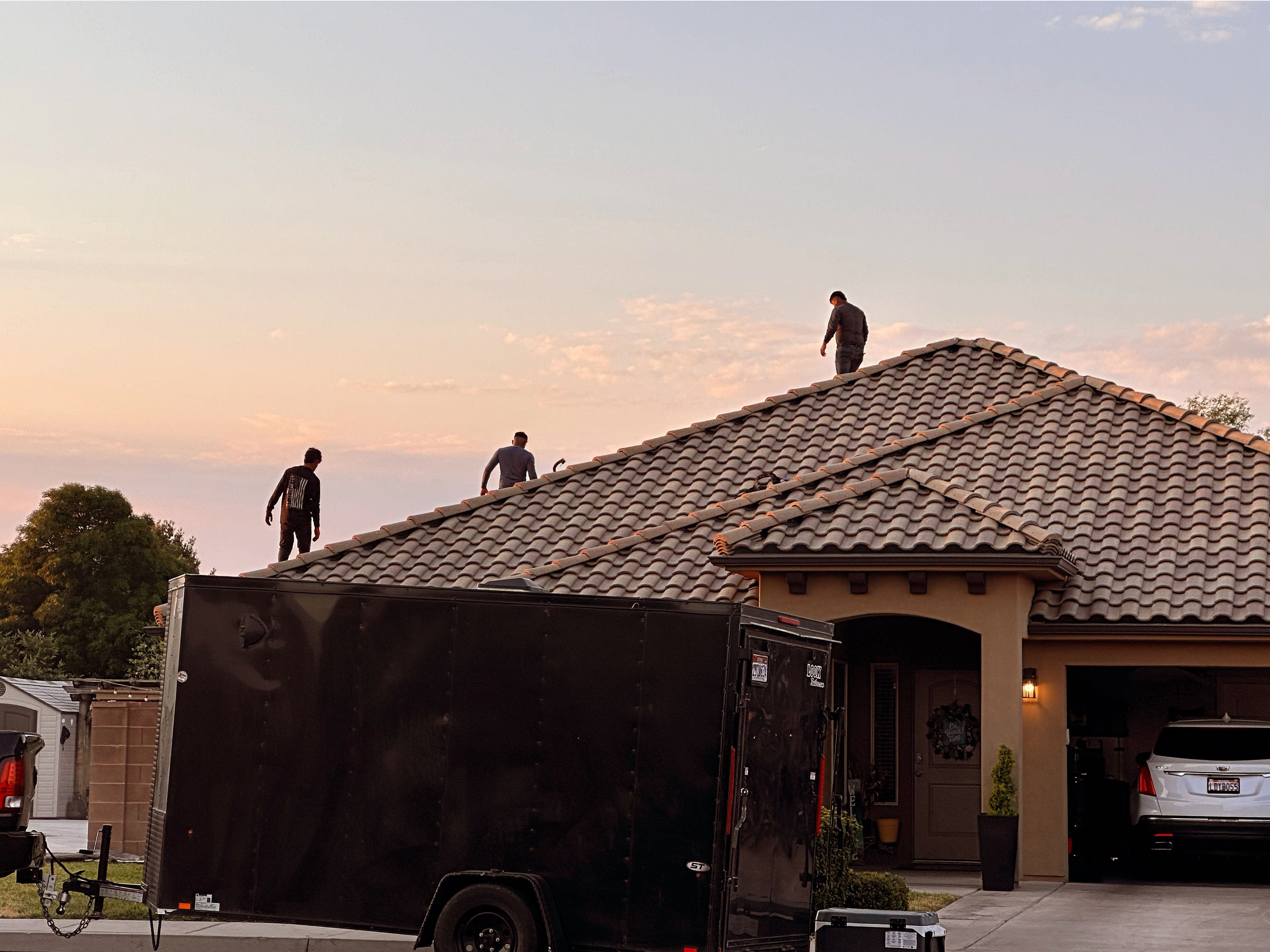 R1 Roofing & Exteriors crew performing tile roof installation in Arizona at sunset