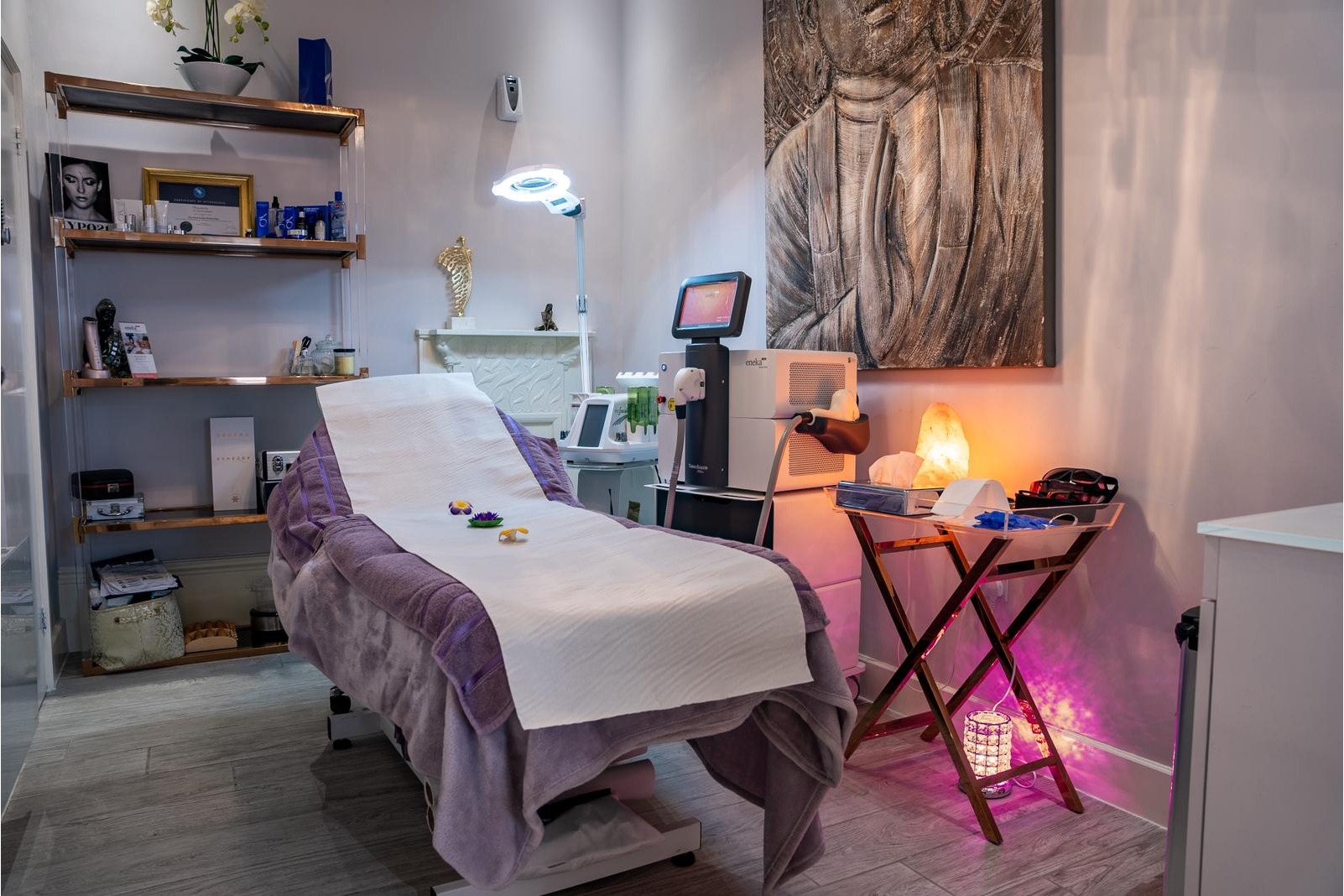 Luxurious aesthetic treatment room at The Harrogate Clinic featuring a comfortable treatment bed, advanced laser equipment, ambient lighting, and elegant d&eacute;cor for skin rejuvenation and cosmetic procedures in Harrogate.