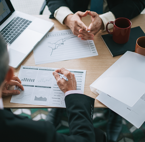 A close-up of wealth professionals reviewing graphs and charts.