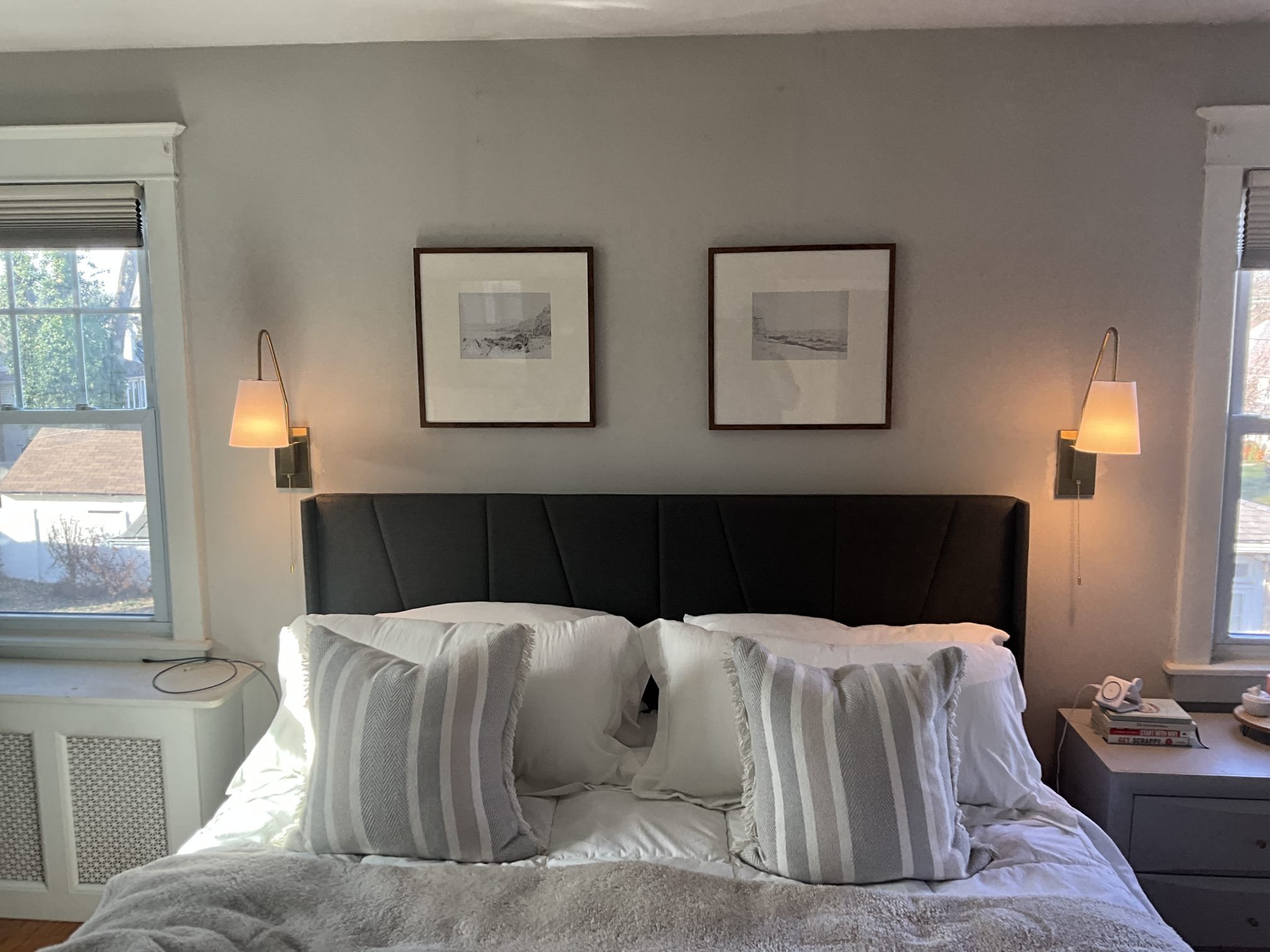 Thomas Edison Electric installed a pair of brass wall sconces with fabric shades on either side of the bed in a Drexel Hill, PA master bedroom. The symmetrical placement provides warm reading light and a polished, designer look without taking up nightstand space.