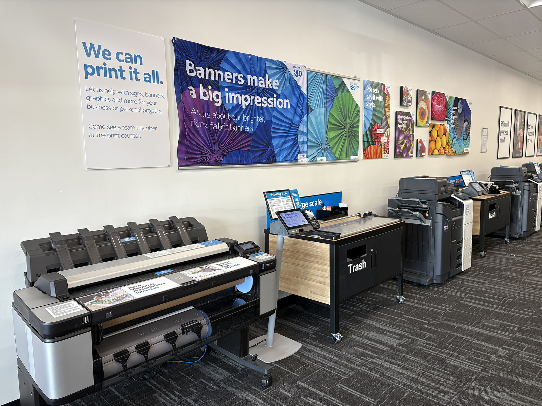 Large Format Printing and Poster Area &ndash; Large format printers and display wall featuring posters, banners, and custom print products.