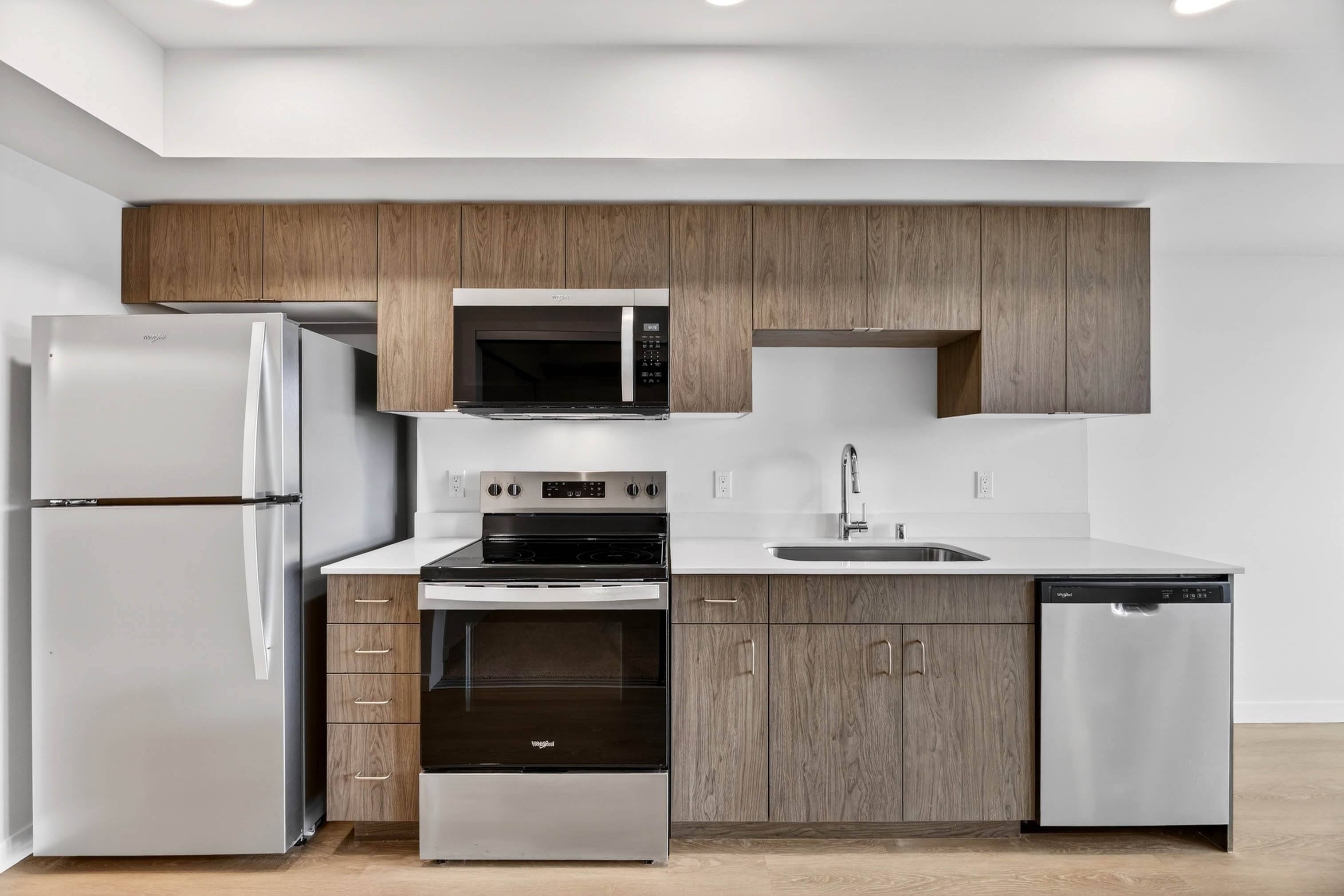 Stainless steel appliances and white countertops