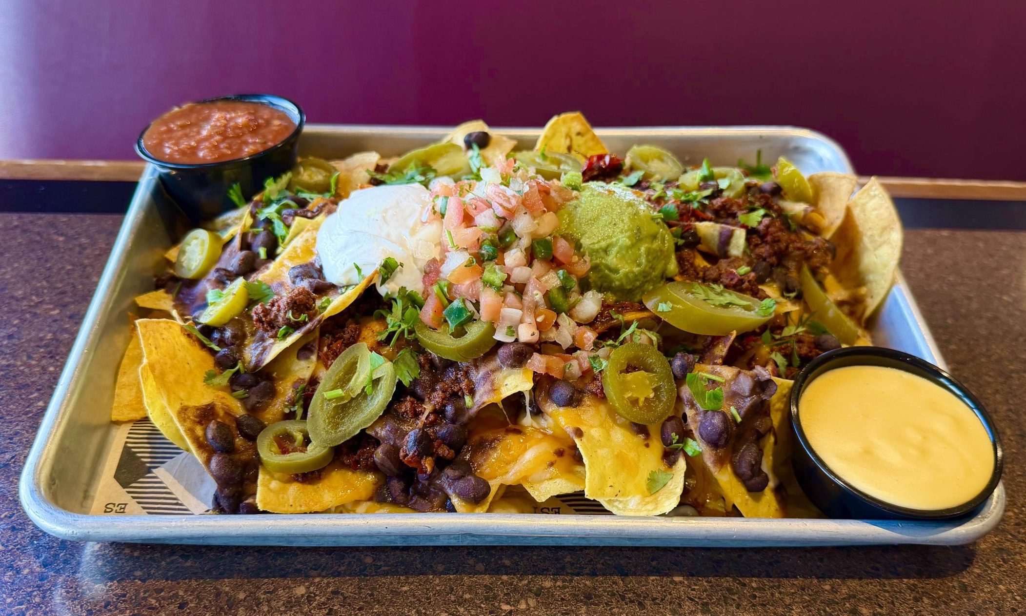 Cheddar jack, black beans, sour cream, roasted jalapeños, cilantro, salsa, pico de gallo, guacamole, salsa.