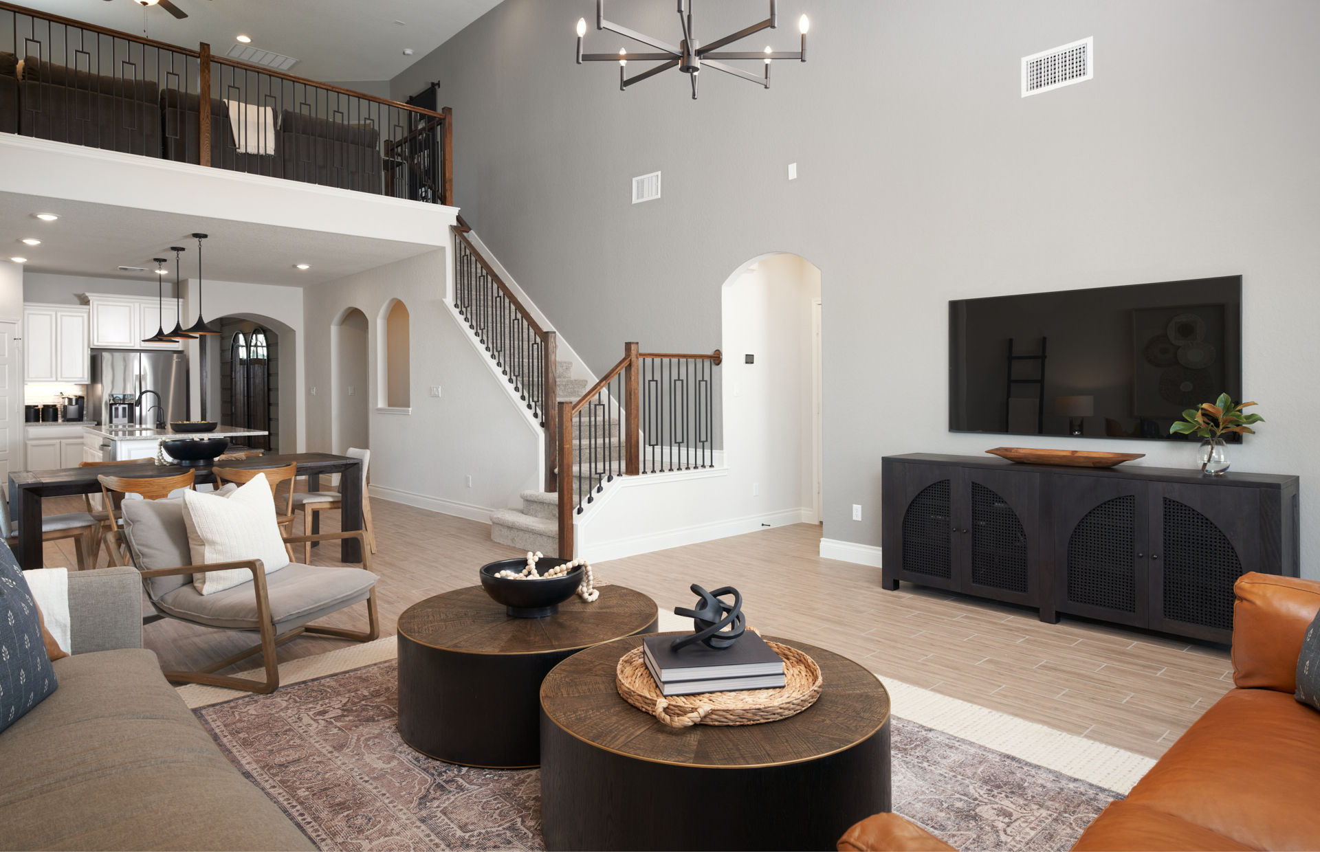 Modern open living room featuring new hardwood floors in new construction home in San Antonio, TX